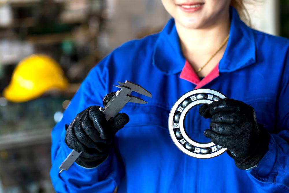woman preparing industrial bearing for replacement